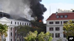 FILE - A fire burns at the Houses of Parliament, in Cape Town, South Africa, January 2, 2022. A man facing terrorism charges over the fire said in an courtroom outburst that he “burned it intentionally.” 