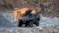 FILE - A Turkish military armored personnel carrier drives past a small patrol base in the mountains of Cukurca in southeastern Turkey, near the Iraqi border, Oct. 21, 2011.