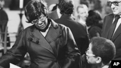 FILE- In this May 27, 1974 file photo, Ella Fitzgerald, left, and jazz pianist Billy Taylor talk during funeral services for Duke Ellington at St. John the Divine Cathedral in New York