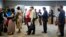 FILE - People are seen waiting in line to meet with recruiters during a job fair in Philadelphia, Pennsylvania.