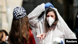A teenager wears a costume as a reference to the coronavirus during the Jewish holiday of Purim, Jerusalem March 8, 2020.