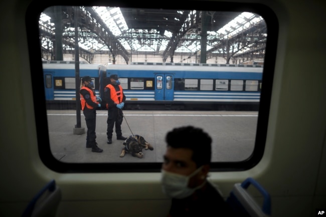 Police guard a train station during a government-ordered lockdown to curb the spread of the new coronavirus, in Buenos Aires, Argentina, Friday, April 24, 2020. (AP Photo/Natacha Pisarenko)