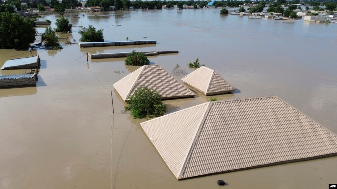 This aerial view shows houses submerged under water in Maiduguri on September 10, 2024.