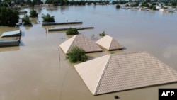 This aerial view shows houses submerged under water in Maiduguri on September 10, 2024.