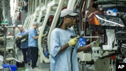 Workers assemble Volkswagen cars at a factory in Chattanooga, Tennessee. Problems with pollution control software could affect as many as 11 million cars worldwide.