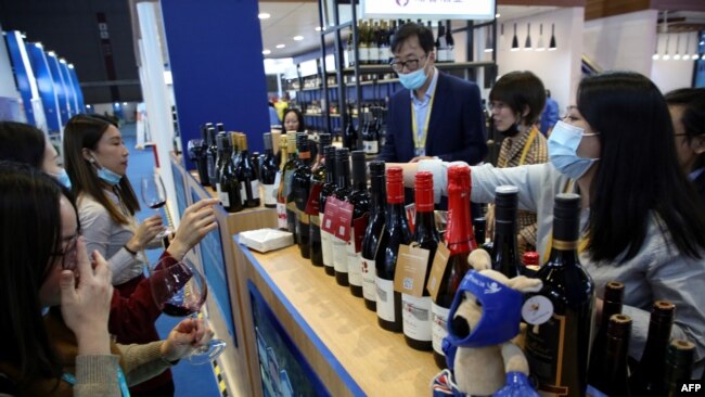 中国消费者在上海举行的第三届国际进口商品展览会上品尝澳大利亚的葡萄酒（2020年11月5日）
