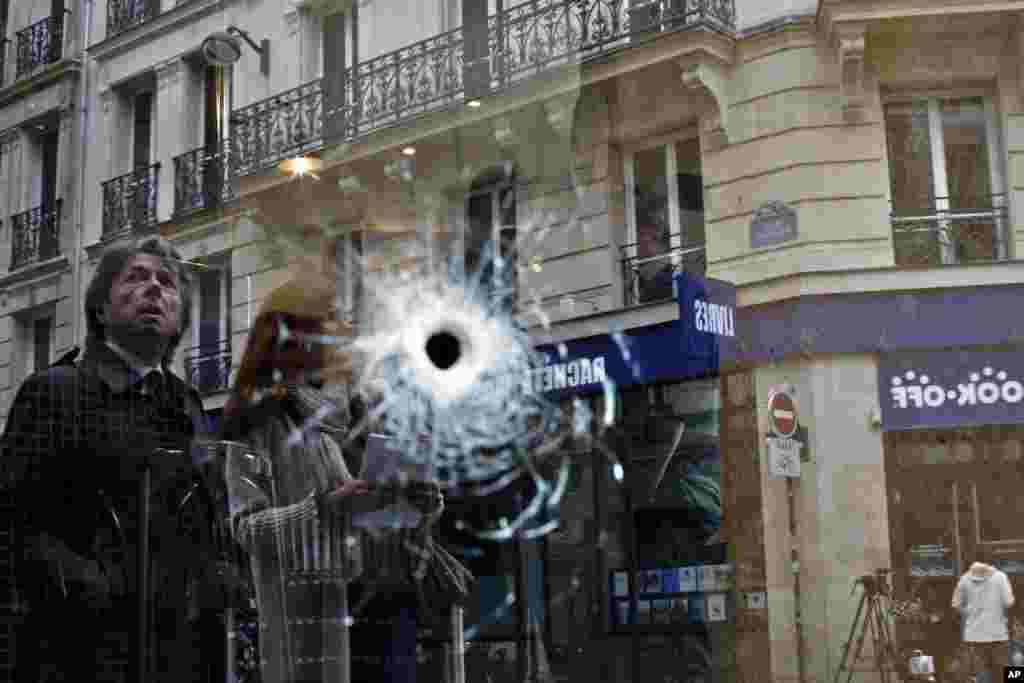 A bullet hole is seen on the window of a cafe located near the area where the assailant of a knife attack was shot dead by police officers in central Paris, France.