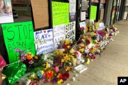 FILE - A makeshift memorial is seen March 19, 2021, in Acworth, Ga., in the aftermath of shootings that left eight people dead at three metro Atlanta massage businesses.