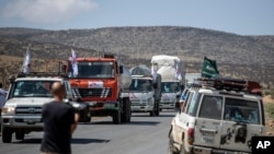 FILE - A convoy of trucks from Medecins Sans Frontieres carrying medical supplies stops by the side of the road after receiving news that the road ahead has been closed by the Ethiopian military, May 8, 2021.