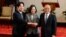Former premier William Lai, left, Taiwan President Tsai Ing-wen and new premier Su Tseng-chang, right, join hands after a news conference in Taipei, Taiwan, Jan. 11, 2019.