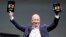 Amazon CEO Jeff Bezos holds up the new Kindle Fire HD 7" and Kindle Fire HD 8.9" (L) during Amazon's Kindle Fire event in Santa Monica, California Sep. 6, 2012. 