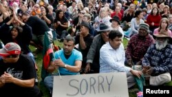 FILE - Crowds gather to watch Prime Minister Kevin Rudd apologize to Aboriginal Australians outside Parliament House in Canberra, Feb. 13, 2008. Australia apologized for the historic mistreatment of Aborigines. The Melbourne Museum has a new exhibition about the massacres of indigenous people.