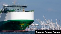 FILE - A cargo ship passes the Port of Baltimore in Baltimore, Oct. 14, 2021.