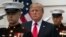 President Donald Trump stands behind and in front of members of a Marine honor guard as he greets Canadian Prime Minister Justin Trudeau and Sophie Gregoire Trudeau as they arrive at the White House in Washington, Oct. 11, 2017.