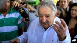 FILE - Uruguay's President Jose Mujica speaks to journalists after laying flowers at a monument of his nation's hero Jose Gervasio Artigas Arnal in Havana, Cuba, July 25, 2013.