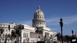 Police stand guard near the National Capitol building in Havana, Cuba, Monday, July 12, 2021, the day after protests against food shortages and high prices amid the coronavirus crisis.