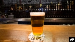 In this July 21, 2017 photo, a glass of craft beer sits on the bar at the RULE Taproom pub in Moscow, Russia. A new generation of craft beer brewers began sprouting in the vodka capital of the world as foreign beers got too expensive.
