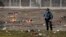 A law enforcement officer looks around the scene following a shooting at the Kansas City Chiefs NFL football Super Bowl celebration in Kansas City, Missouri, Feb. 14, 2024. 