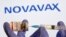 រូបឯកសារ៖ នៅ​ក្នុង​រូបថត​កាល​ពី​ថ្ងៃទី៣០ ខែតុលា ឆ្នាំ២០២០ នេះ បង្ហាញ​ពី​ដប​វ៉ាក់សាំង​មួយ​ដែល​មាន​ស្លាកសញ្ញា​ថា «វ៉ាក់សាំង​បង្ការ​ជំងឺ​កូវីដ១៩» និង​ម្ជុល​ចាក់​ថ្នាំ​មួយ​នៅ​ពី​មុខ​ស្លាកសញ្ញា​ក្រុមហ៊ុន Novavax។