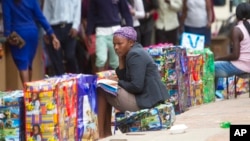 A Zimbabwean vendor selling some goods ... (AP)