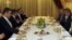 Turkey's Foreign Minister Ahmet Davutoglu (2nd L) and defected Syrian General Manaf Tlas (2nd R) meet around an Iftar dinner table as they are flanked by Turkey's intelligence agency undersecretary Hakan Fidan (L) and other officials, in Ankara, Turkey, J