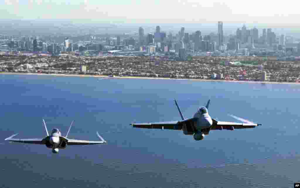 Two Royal Australian Air Force fighter jets, an F/A-18 Hornet (L) and an F/A-18F Super Hornet, fly over Port Philip Bay as part of the Australian International Airshow in Melbourne on March 2. (Reuters/Commonwealth of Australia)