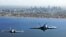 Two Royal Australian Air Force fighter jets, an F/A-18 Hornet (L) and an F/A-18F Super Hornet, fly over Port Philip Bay as part of the Australian International Airshow in Melbourne on March 2. (Reuters/Commonwealth of Australia)