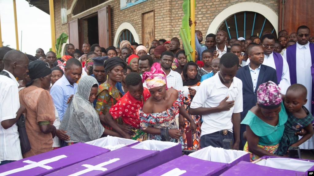 FILE - People view the bodies of people killed following an attack by a rebel group RED-Tabara based in the neighboring Democratic Republic of Congo on Friday, at the St François Xavier parish church, in Gatumba, Burundi, December 26, 2023.