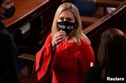 FILE - U.S. Rep. Marjorie Taylor Greene, R-Ga., wears a "Trump Won" face mask as she arrives at the House floor to take her oath of office as a new member of the 117th House of Representatives in Washington, D.C. Jan. 3, 2021.