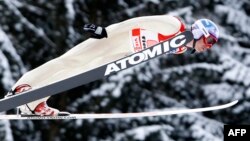 FILE - Bill Demong of the U.S. soars through the air during the LH team sprint ski jumping portion of the World Cup Nordic Combined event in the northern mountain resort of Predazzo, Feb. 4, 2012. 