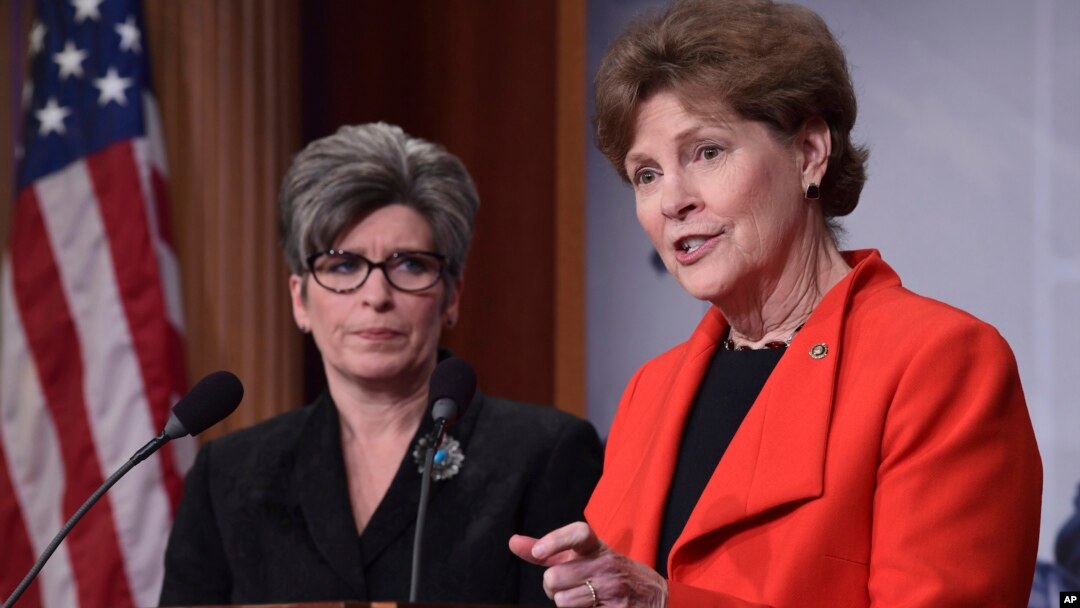 Sen. Jeanne Shaheen, D-N.H., right, standing with Sen. Joni Ernst, R-Iowa, announces in Washington, Feb. 7, 2018, a bipartisan resolution that would establish a special Senate committee to investigate the USOC and USA Gymnastics regarding how team doctor Larry Nassar was allowed to sexually abuse female gymnasts over decades. 