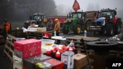 Farmers attend a blocking of the A62 highway near Agen, France, on Jan. 27, 2024, as part of a nationwide movement of protests called by several farmers' unions on pay, tax and regulations.