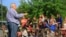 "Reverend Jim Lavender, Jr. gives a children's Bible sermon at a church parking lot using rescued circus animals, in Centreville, Virginia on May 4, 2013." (Jill Craig/VOA) 