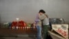 People react at a memorial set up on Bourbon Street on January 2, 2025 in New Orleans, Louisiana, the day after an attack by a man driving a truck down Bourbon street in the French Quarter.