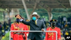 Ugandan President Yoweri Museveni waves to the crowd as he arrives to take his oath to be sworn in as president for his sixth term, at Kololo ceremonial grounds, in Kololo, Uganda, May 12, 2021.