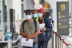 FILE - People line up to get their coronavirus disease (COVID-19) test at Songshan airport following an increasing number of locally transmitted cases in Taipei, Taiwan, June 2, 2021.