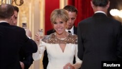 FILE - French First Lady Brigitte Macron attends a state dinner held at the Elysee Palace in Paris, France, March 19, 2018. 
