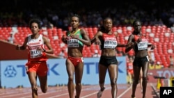 FILE - (L to R) Bahrain's Mimi Belete, Ethiopia's Genzebe Dibaba, Kenya's Mercy Cherono and Kenya's Irene Chepet Cheptai, compete in the women’s 5000m at the World Athletics Championships at the Bird's Nest stadium in Beijing, China, Aug. 27, 2015.