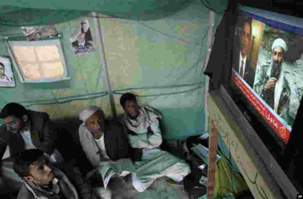 Anti-government protestors watch a TV broadcasting a report about the killing of Al-Qaida leader Osama bin Laden, in a tent at the site of a demonstration demanding the resignation of Yemeni President Ali Abdullah Saleh, in Sanaa,Yemen, Monday, May 2, 201
