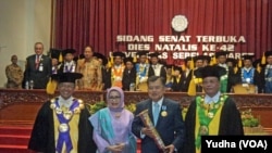 Wapres Jusuf Kalla (tiga dari kiri, berjas) didampingi istri (dua dari kiri, berkerudung) menerima penghargaan dari rektor UNS (paling kiri), Senin (12/3). (Foto: VOA/Yudha) 