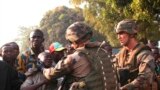 French military personnel try to control supporters who are asking them to disarm fighting gangs, near the airport in Bangui, Central African Republic. France appealed to European partners for assistance in quelling months of religious violence in its former colony.