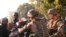 French military personnel try to control supporters who are asking them to disarm fighting gangs, near the airport in Bangui, Central African Republic. France appealed to European partners for assistance in quelling months of religious violence in its former colony.