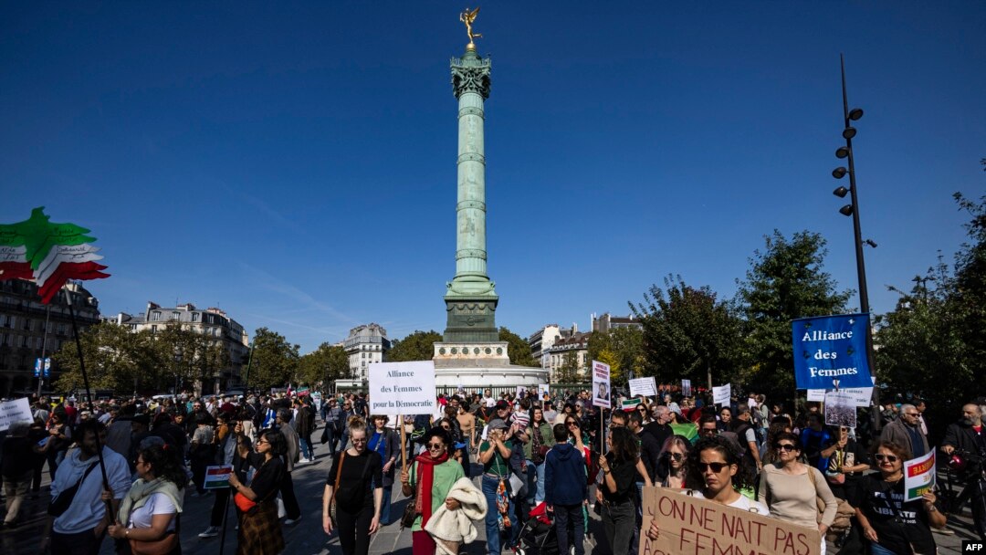 Protesters take part in a march on the second anniversary of a protest movement sparked by the death in custody of Mahsa Amini, 22, arrested for allegedly violating the dress code for women at Place de la Bastille, in Paris, Sept. 15, 2024.