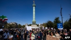 Protesters take part in a march on the second anniversary of a protest movement sparked by the death in custody of Mahsa Amini, 22, arrested for allegedly violating the dress code for women at Place de la Bastille, in Paris, Sept. 15, 2024.