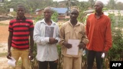 Left to right, Manso Turay, James Conteh, Father Kargbo, Mohamed Barrie pose outside the Radisson hotel in Freetown, Feb. 5, 2018, before a hearing where a British court heard testimony of the alleged complicity of a British mining company in police brutality, including rape. 