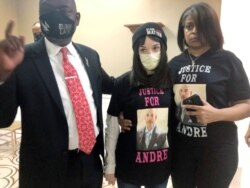 FILE - Attorney Benjamin Crump, left, discusses the police shooting of Andre Hill at a news conference attended by Hill's daughter, Karissa, center, and sister Shawna Barnett, December 31, 2020, in Columbus, Ohio.