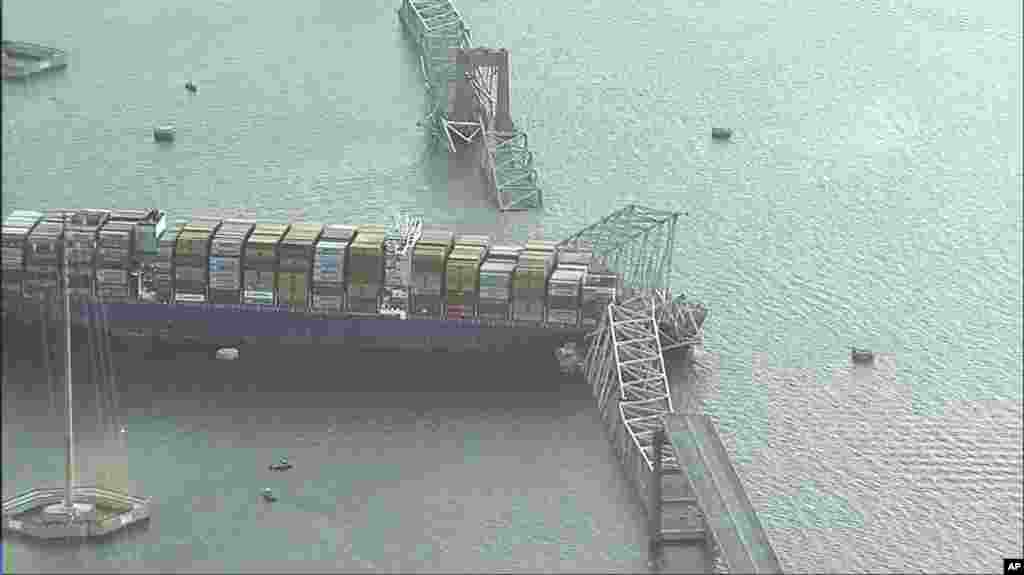 Parts of the Francis Scott Key Bridge remain after a container ship collided with a support, March 26, 2024 in Baltimore.&nbsp;(WJLA via AP)