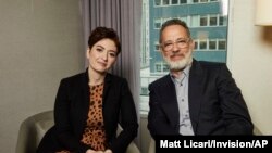 This Nov. 17, 2019 photo shows Marielle Heller, left, and Tom Hanks pose for a portrait in New York to promote their film, "A Beautiful Day In The Neighborhood." 