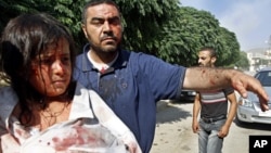 Injured Syrians arrive at a field hospital after an air strike hit their homes in the town of Azaz on the outskirts of Aleppo, Syria, Aug. 15, 2012.