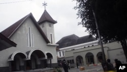 Soldiers stand guard outside a church after it was attacked by a mob in Temanggung on February 8, 2011. Hundreds of Muslim radicals set two churches ablaze and attacked a court in Indonesia's central Java, calling for harsh punishment for a Christian on t